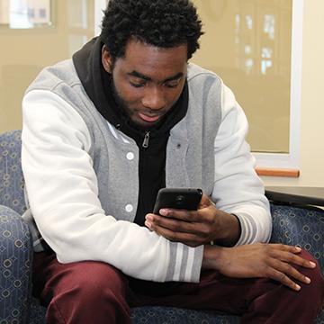 person sitting down using phone